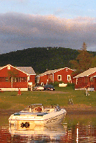 A boat moored off of Jackson's sandy beach as a father and son "play catch" on the shore (Click for larger image.)